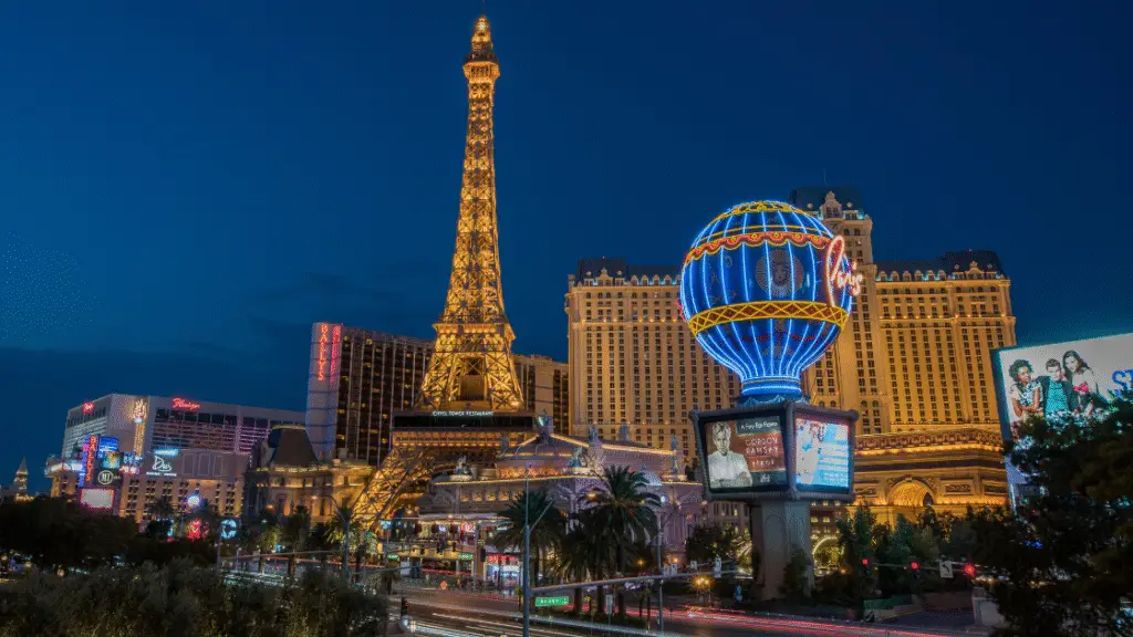 Illuminated buildings and attractions on the Las Vegas Strip at night.