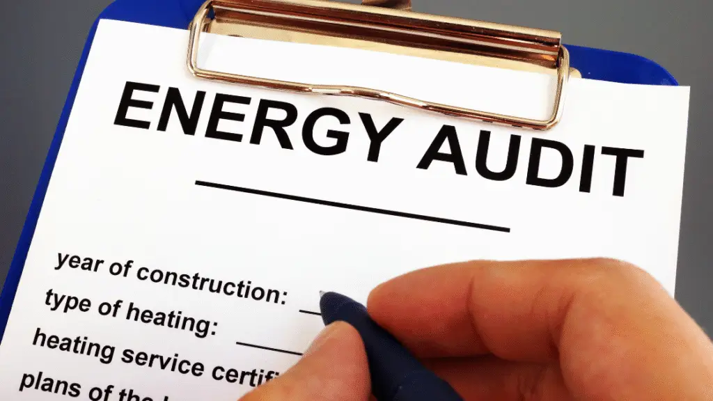 Energy audit form on a clipboard with a hand writing on it using a pen.