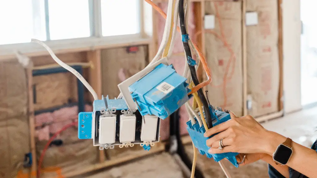 Close-up of electrical switches and wiring being installed in a home renovation project.