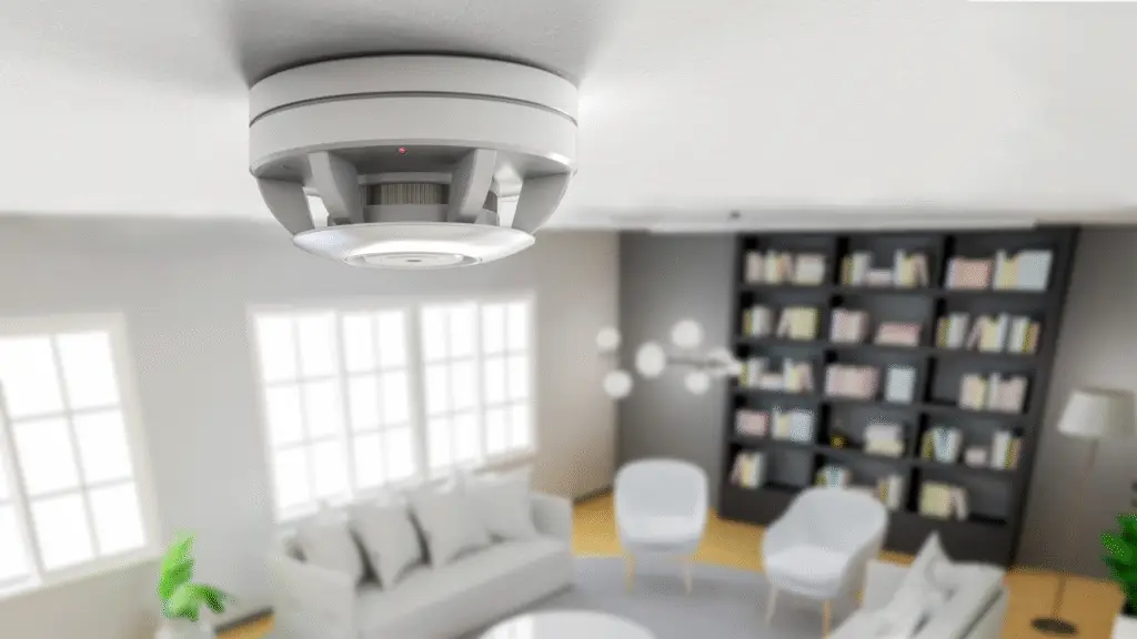 Carbon monoxide detector installed on the ceiling in a modern indoor setting.